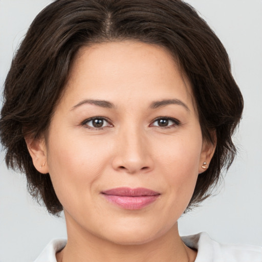 Joyful white young-adult female with medium  brown hair and brown eyes