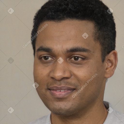 Joyful black young-adult male with short  black hair and brown eyes