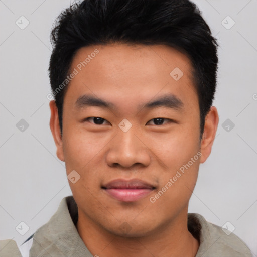 Joyful asian young-adult male with short  black hair and brown eyes