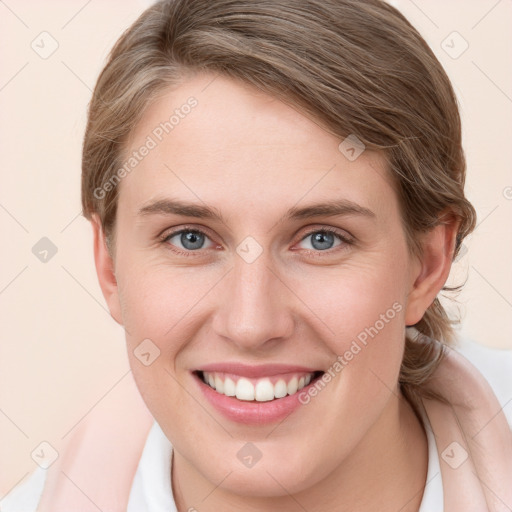 Joyful white young-adult female with medium  brown hair and grey eyes