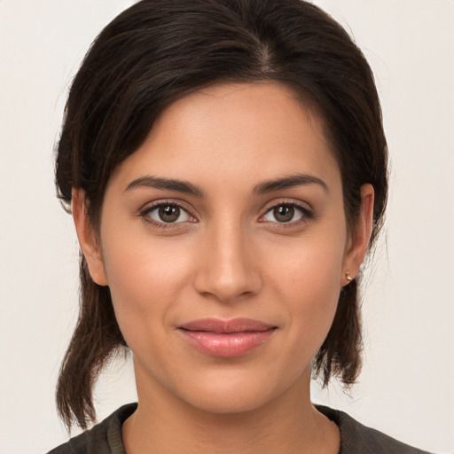 Joyful white young-adult female with medium  brown hair and brown eyes