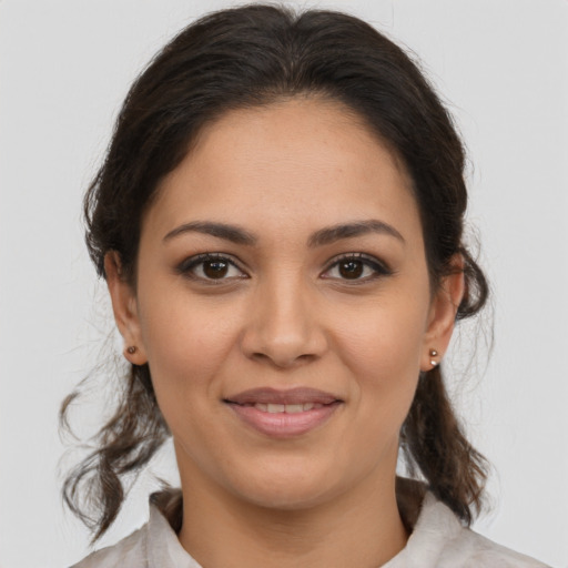 Joyful latino young-adult female with medium  brown hair and brown eyes