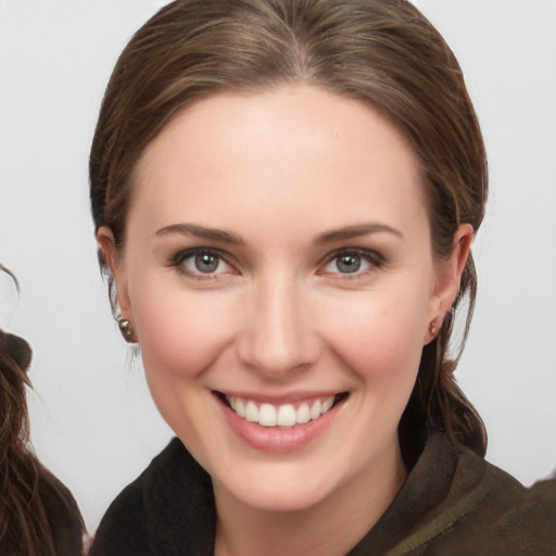 Joyful white young-adult female with long  brown hair and brown eyes