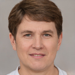 Joyful white adult male with short  brown hair and grey eyes