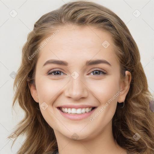 Joyful white young-adult female with long  brown hair and blue eyes