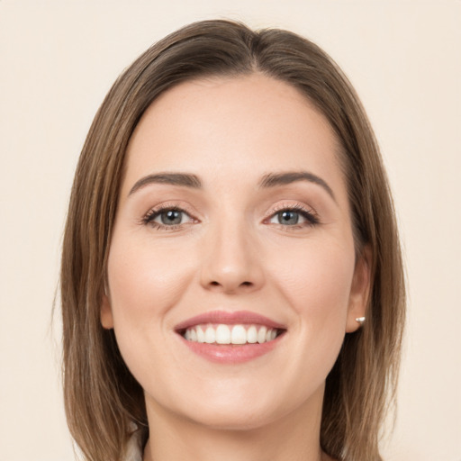 Joyful white young-adult female with long  brown hair and green eyes