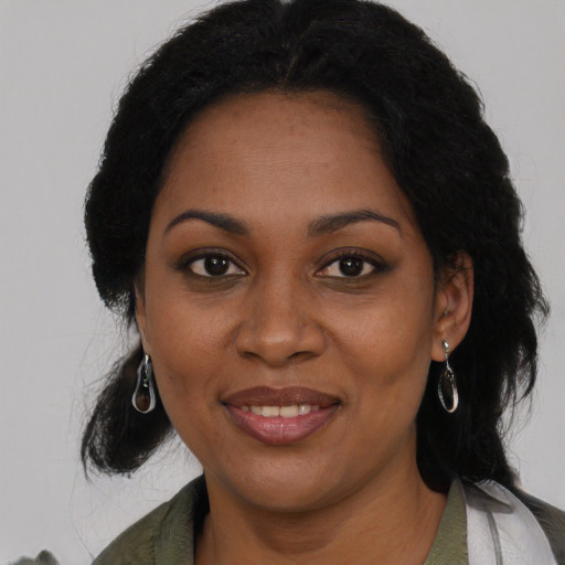 Joyful black young-adult female with medium  brown hair and brown eyes