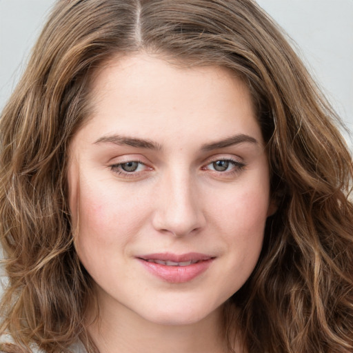 Joyful white young-adult female with long  brown hair and green eyes