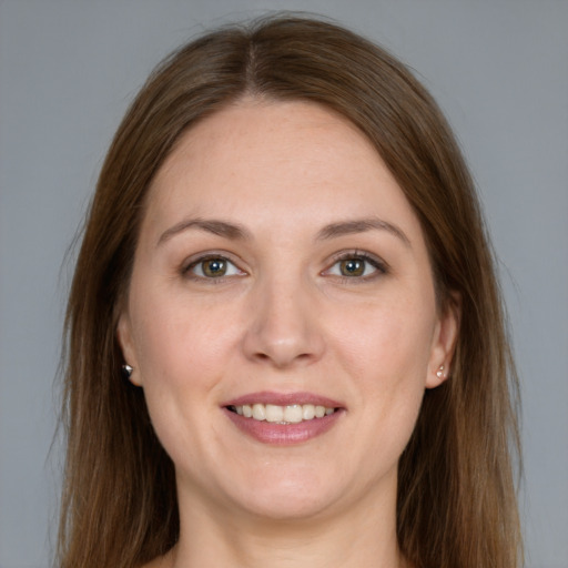 Joyful white young-adult female with long  brown hair and grey eyes