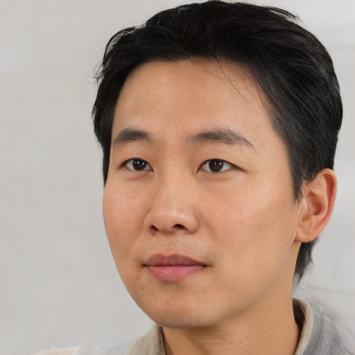Neutral asian young-adult male with short  black hair and brown eyes