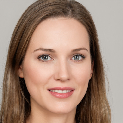 Joyful white young-adult female with long  brown hair and grey eyes