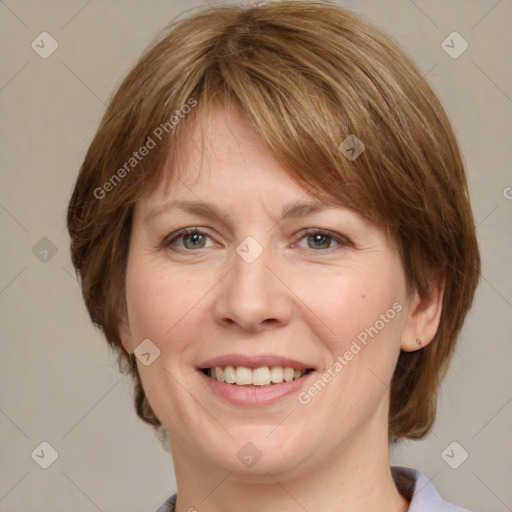 Joyful white adult female with medium  brown hair and grey eyes