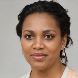 Joyful black young-adult female with medium  brown hair and brown eyes