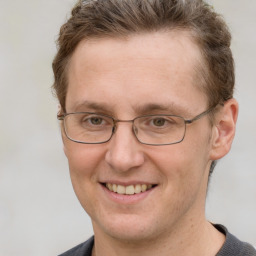 Joyful white adult male with short  brown hair and grey eyes