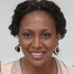 Joyful black adult female with short  brown hair and brown eyes