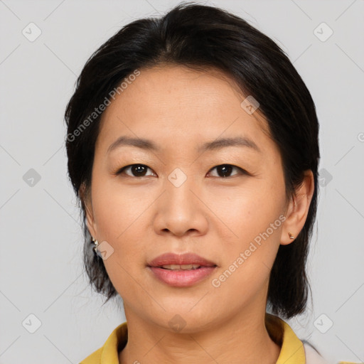 Joyful asian adult female with medium  brown hair and brown eyes