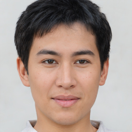 Joyful asian young-adult male with short  brown hair and brown eyes