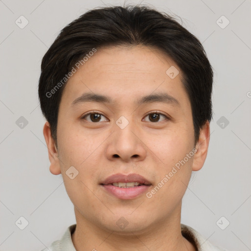 Joyful asian young-adult male with short  brown hair and brown eyes