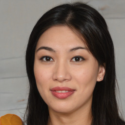 Joyful asian young-adult female with long  brown hair and brown eyes