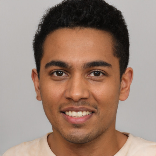 Joyful latino young-adult male with short  black hair and brown eyes