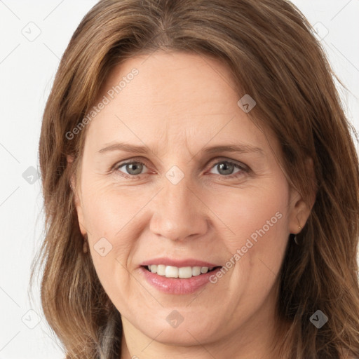 Joyful white adult female with long  brown hair and brown eyes