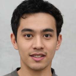 Joyful asian young-adult male with short  black hair and brown eyes