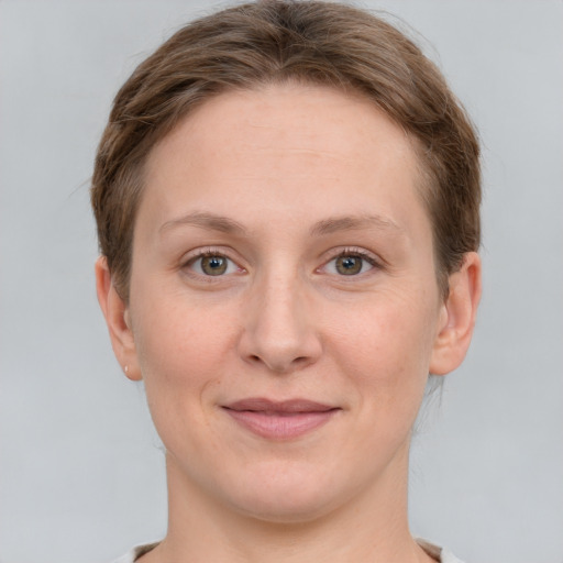 Joyful white adult female with short  brown hair and grey eyes