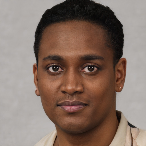 Joyful black young-adult male with short  black hair and brown eyes