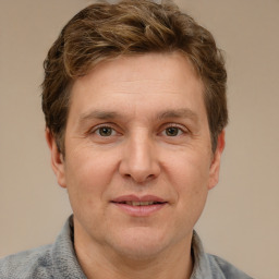 Joyful white adult male with short  brown hair and grey eyes