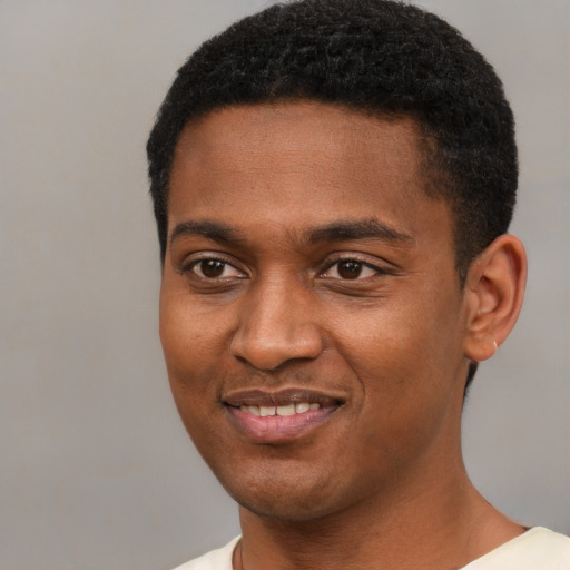 Joyful black young-adult male with short  black hair and brown eyes