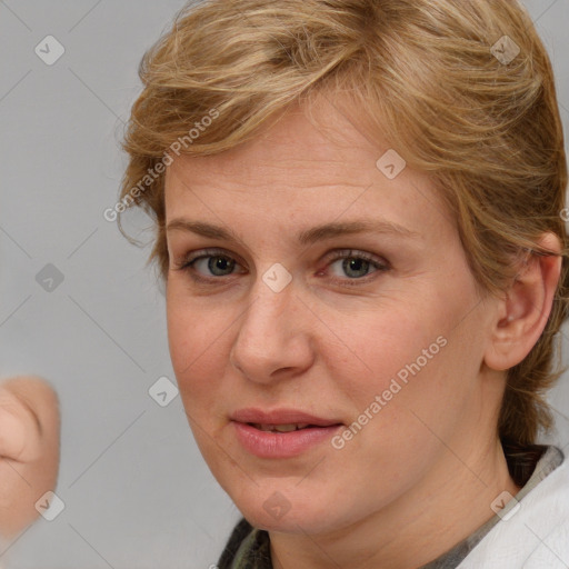 Joyful white adult female with medium  brown hair and blue eyes