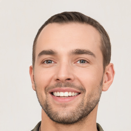 Joyful white young-adult male with short  brown hair and brown eyes