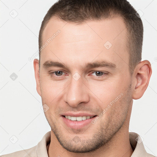 Joyful white young-adult male with short  brown hair and brown eyes