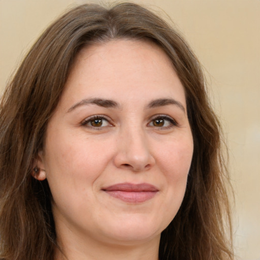 Joyful white young-adult female with long  brown hair and green eyes