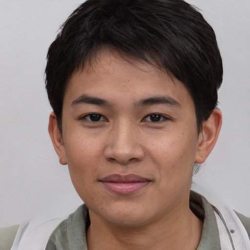 Joyful asian young-adult male with short  brown hair and brown eyes