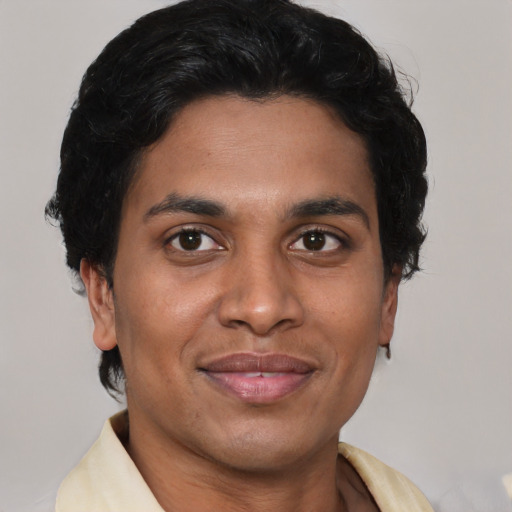 Joyful latino adult male with short  brown hair and brown eyes