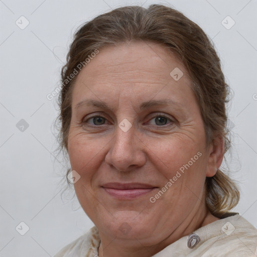 Joyful white adult female with medium  brown hair and grey eyes