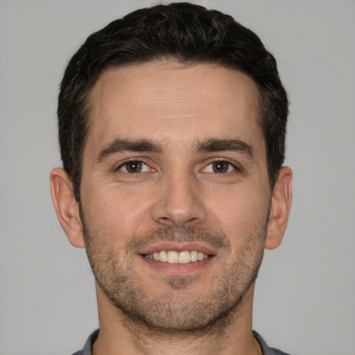 Joyful white young-adult male with short  brown hair and brown eyes