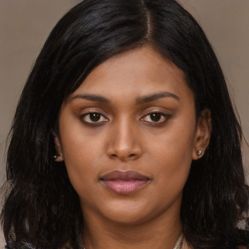 Joyful latino young-adult female with long  black hair and brown eyes