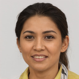 Joyful latino young-adult female with medium  brown hair and brown eyes