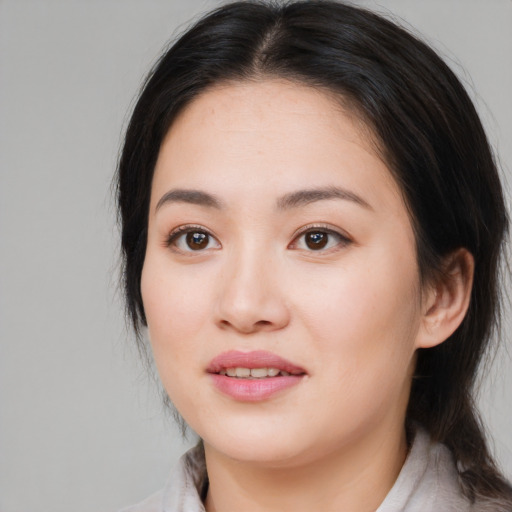 Joyful asian young-adult female with medium  brown hair and brown eyes