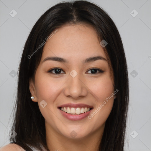 Joyful asian young-adult female with long  brown hair and brown eyes