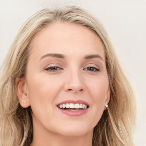 Joyful white young-adult female with long  brown hair and blue eyes