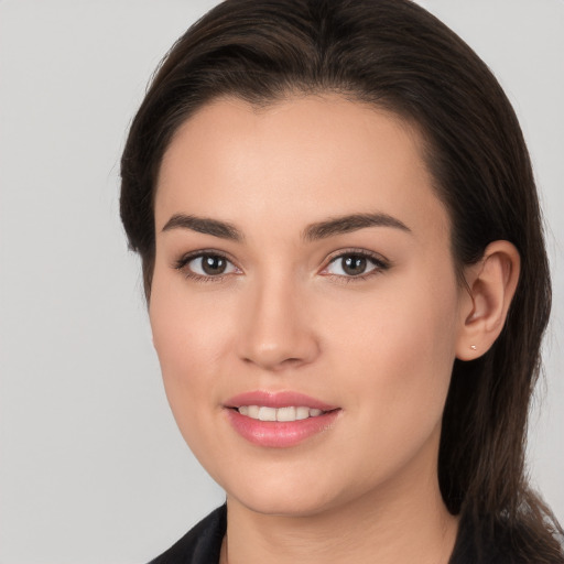 Joyful white young-adult female with long  brown hair and brown eyes