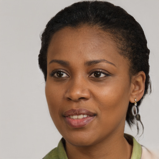 Joyful black young-adult female with medium  brown hair and brown eyes