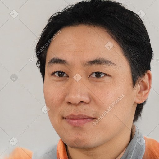 Joyful asian young-adult male with short  brown hair and brown eyes