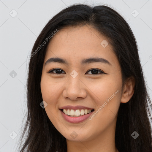 Joyful asian young-adult female with long  brown hair and brown eyes