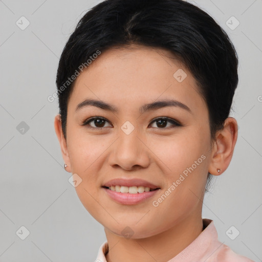 Joyful asian young-adult female with short  black hair and brown eyes