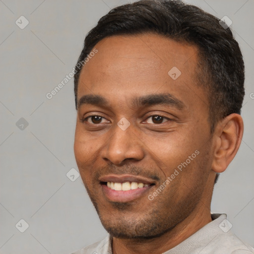 Joyful black young-adult male with short  black hair and brown eyes