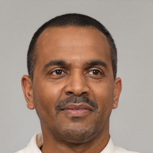 Neutral latino adult male with short  black hair and brown eyes